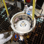 The cruise stage and solar arrays are being installed on the InSight spacecraft in a clean room at Lockheed Martin.